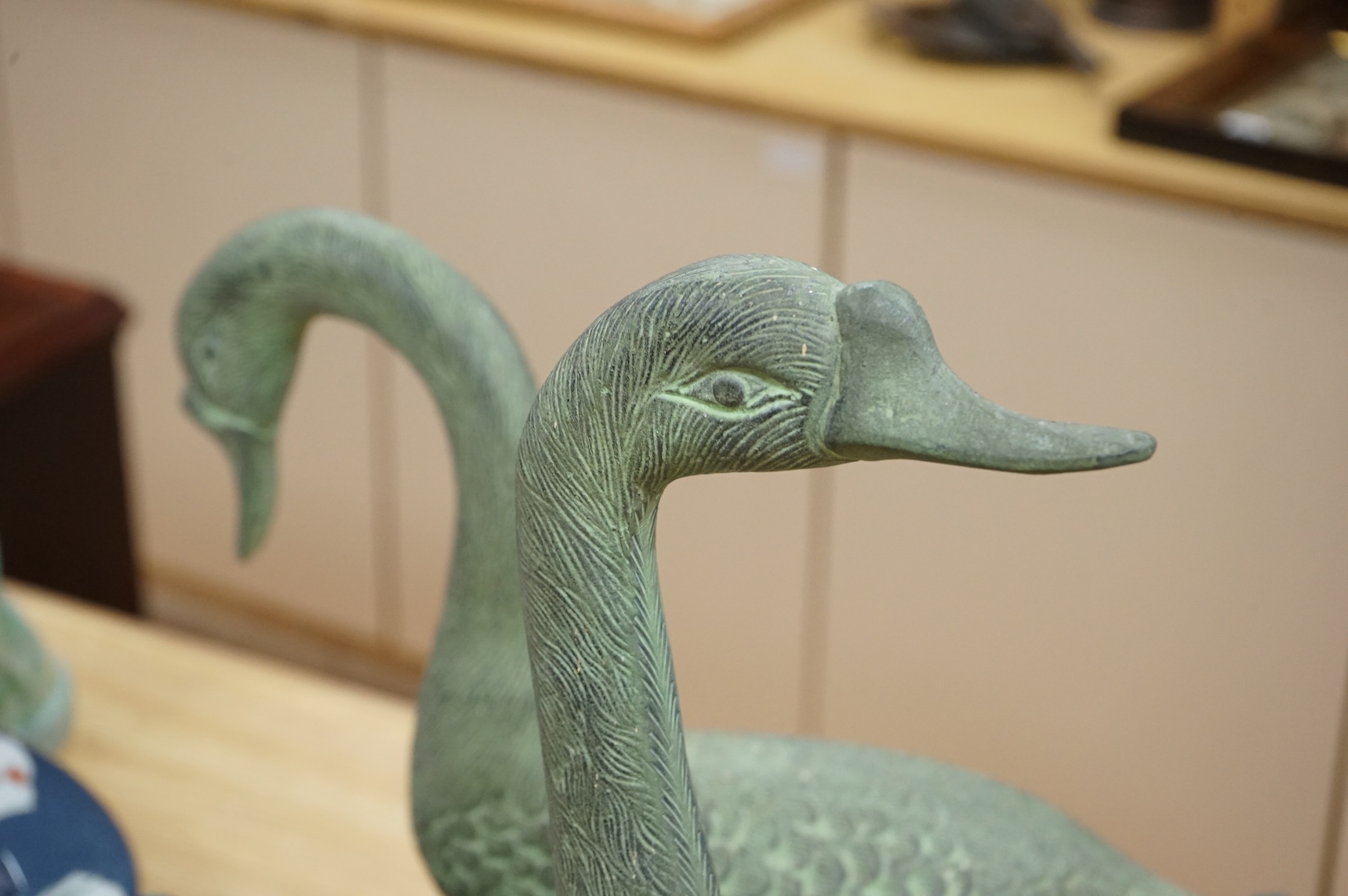 A pair of patinated spelter models of geese, 49cm